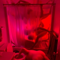 Composite image of  several morphed human bodies in a bathroom using vibrant colors